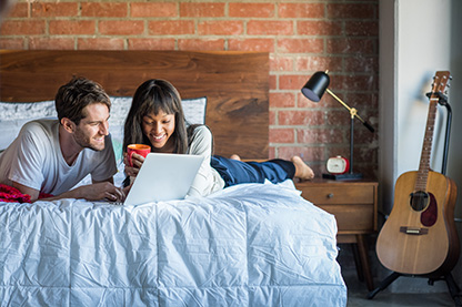 young couple in apartment researching earthquake insurance o