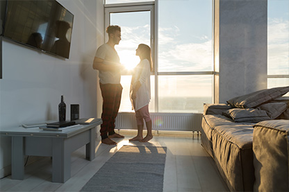 mage: young couple in condo facing each other with sunshine